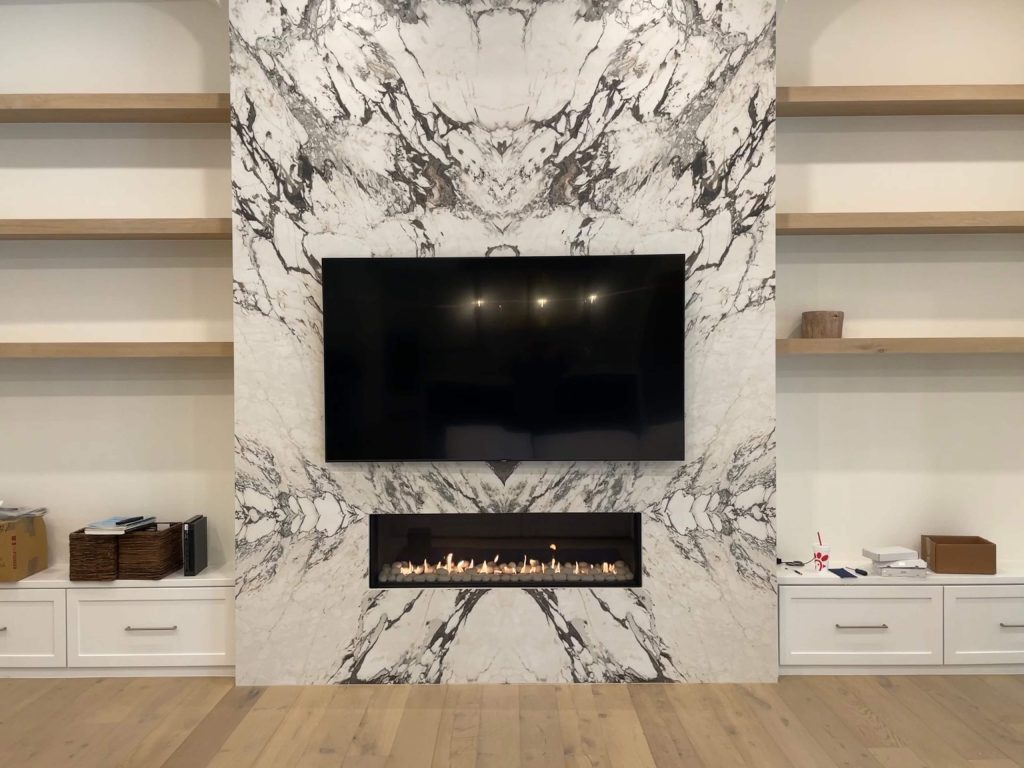Fireplace Wall with TV and shelves on both sides.